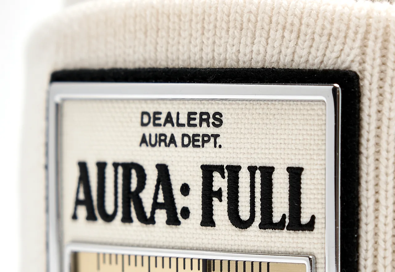 Close-up of a cream Dealers Aura Full beanie label