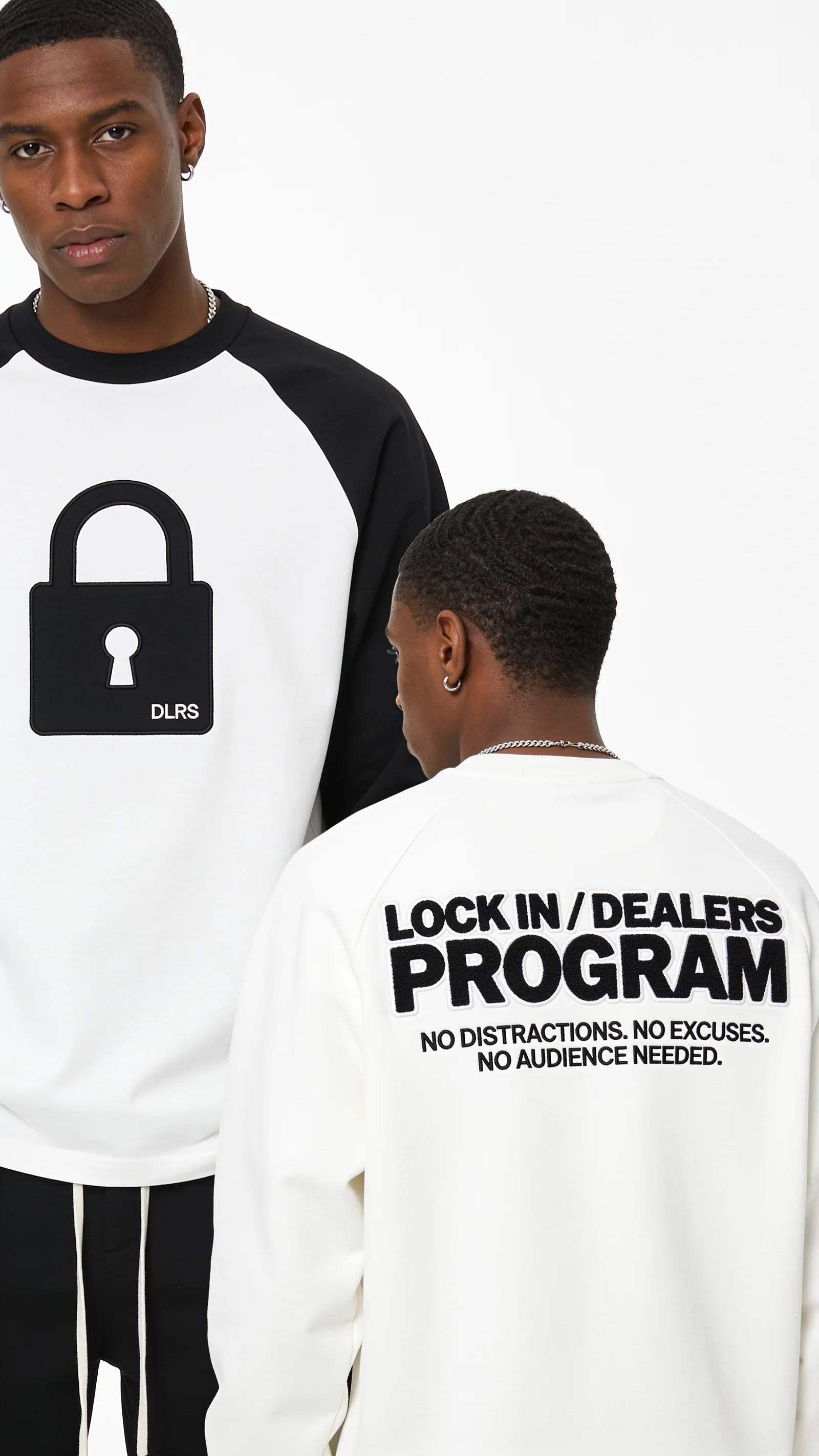 Models wearing black and white Dealers Program pieces on a white studio background